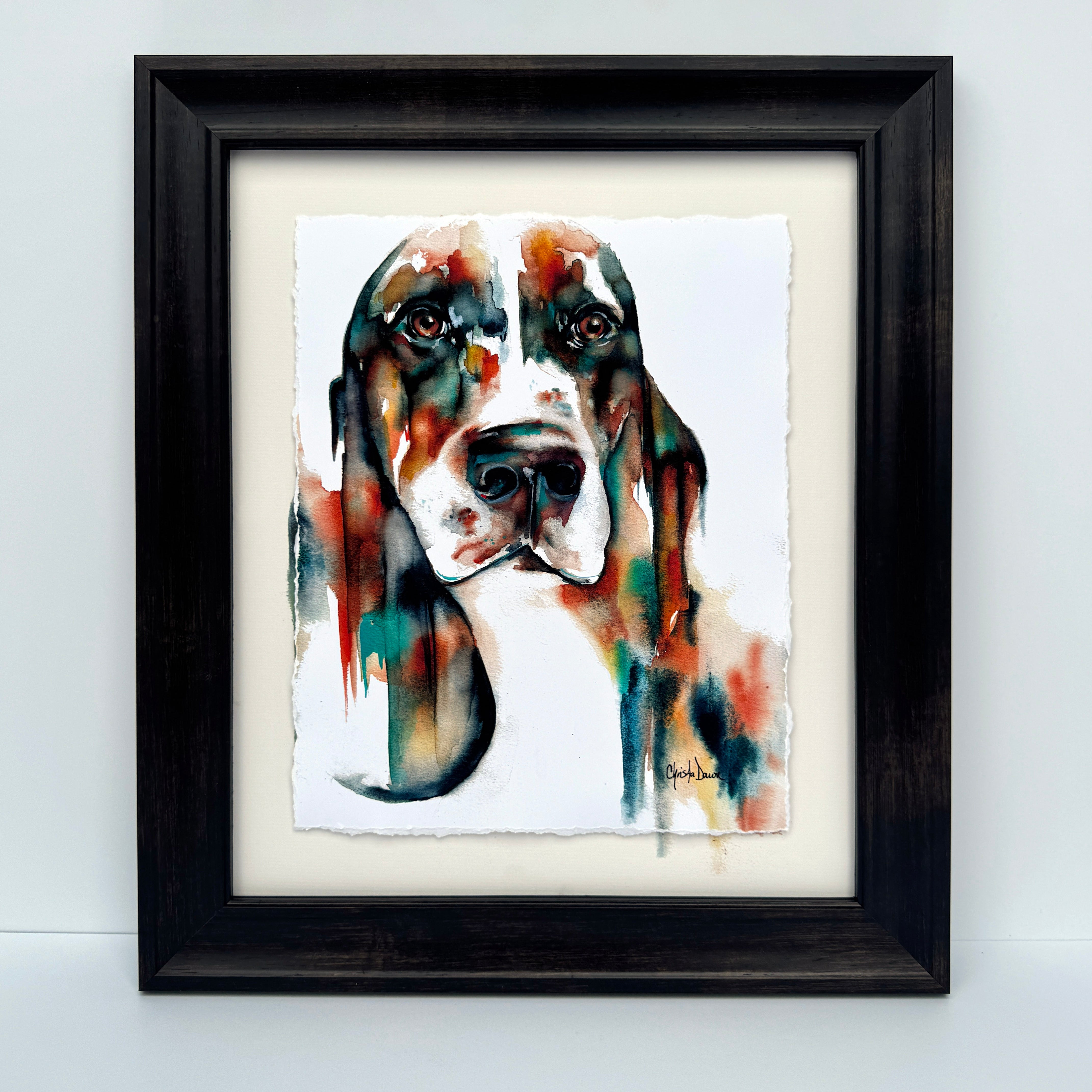 Bold colored watercolor basset on paper with soulful eyes
